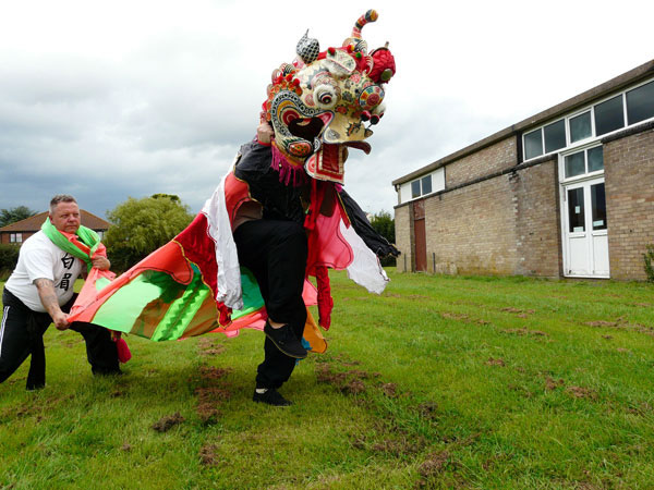 Golden cockerel on one leg